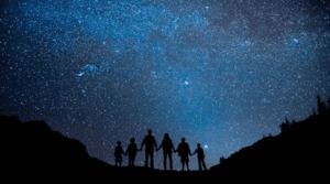 Family looking at stars at night